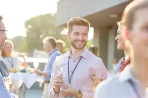 Colleagues Smiling At A Corporate Event
