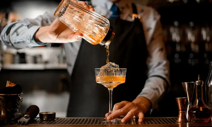 Male Bartender Making Crafted Cocktail